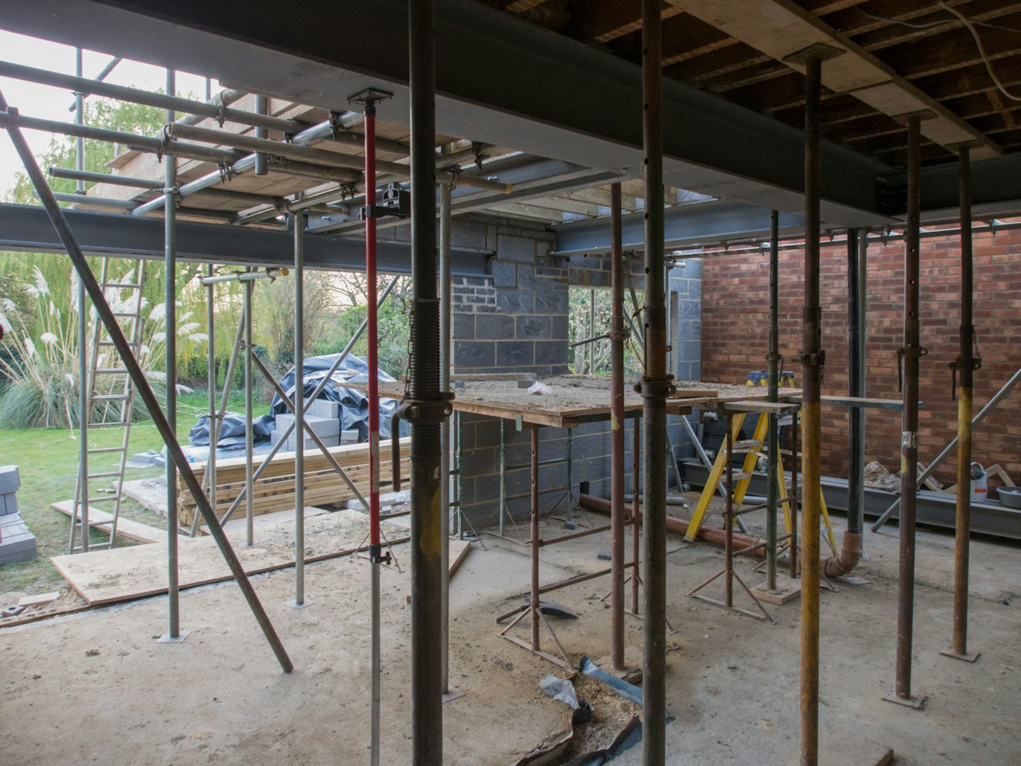 Home Steel beams and scaffolding in a house under construction.