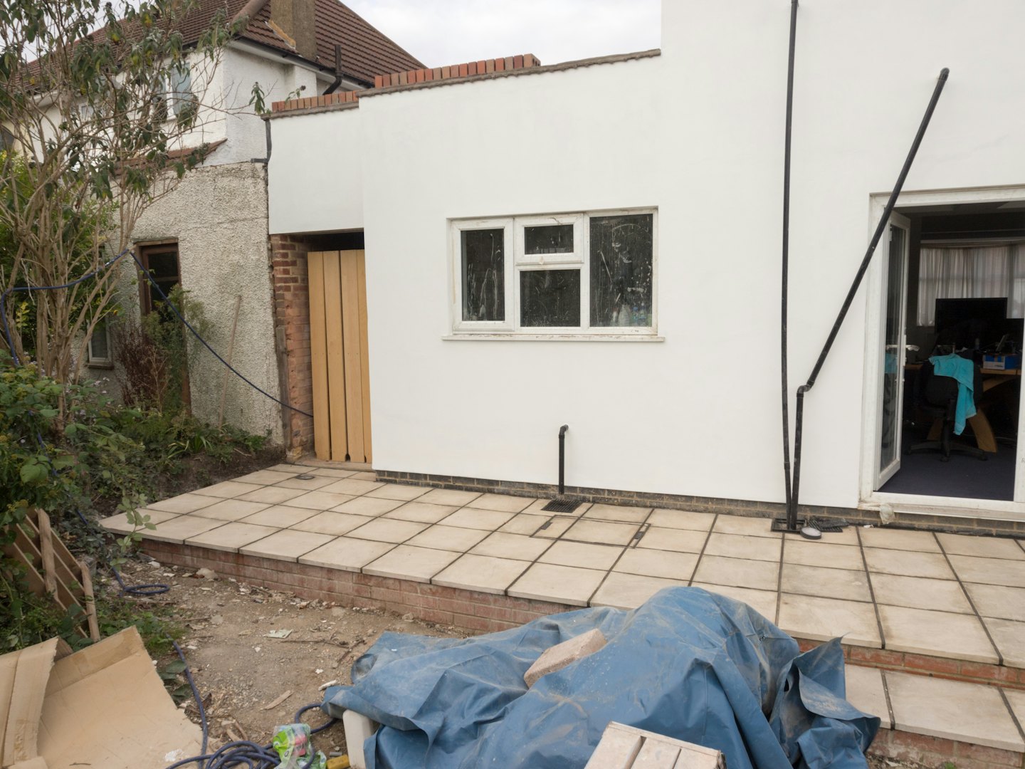 Home Residential building extension under construction with a new patio area.