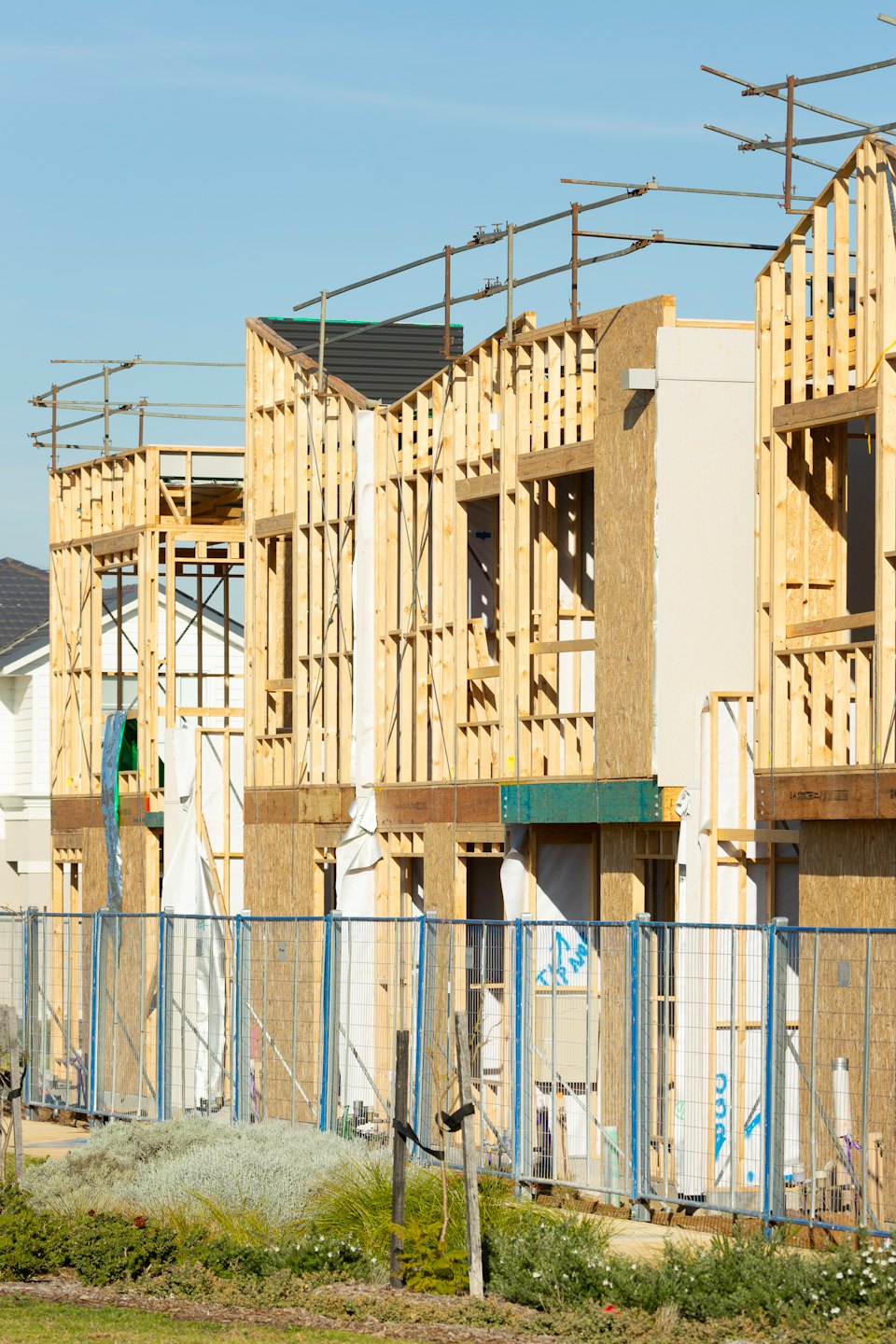 Home Wooden skeletons of new residential buildings under construction.